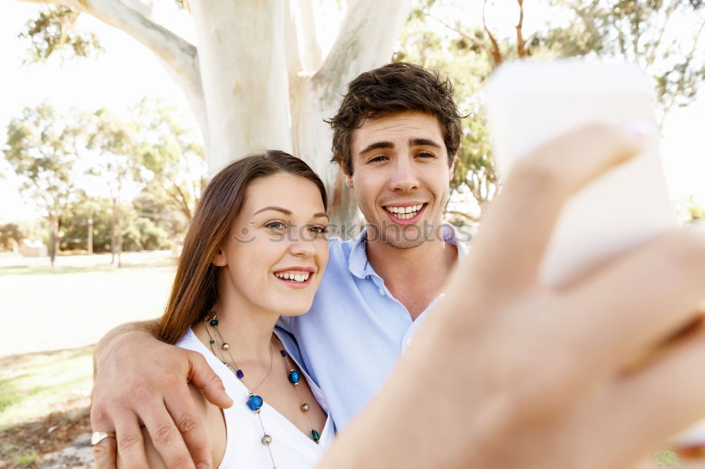 Similar – young cheerful couple taking a selfie