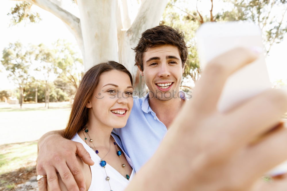 Similar – young cheerful couple taking a selfie