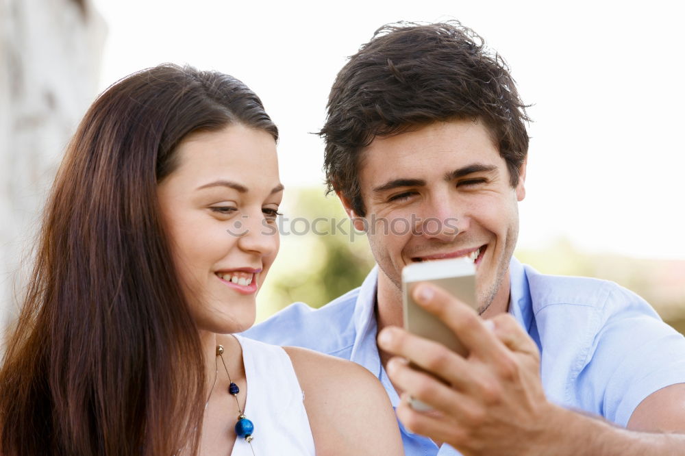 Similar – young cheerful couple taking a selfie