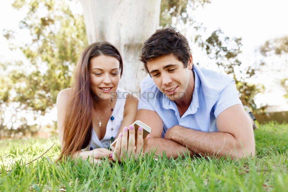 Similar – Beautiful young couple laying on grass in an urban park