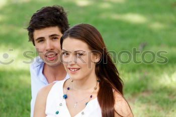 Similar – Beautiful young couple laying on grass in an urban park