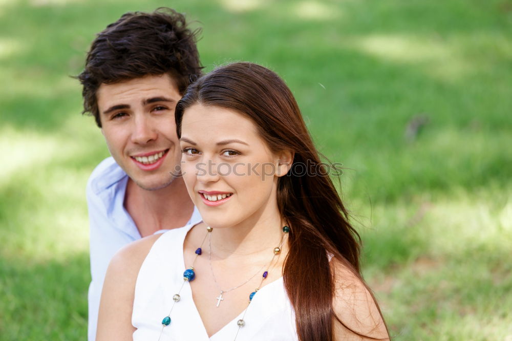 Similar – Beautiful young couple laying on grass in an urban park