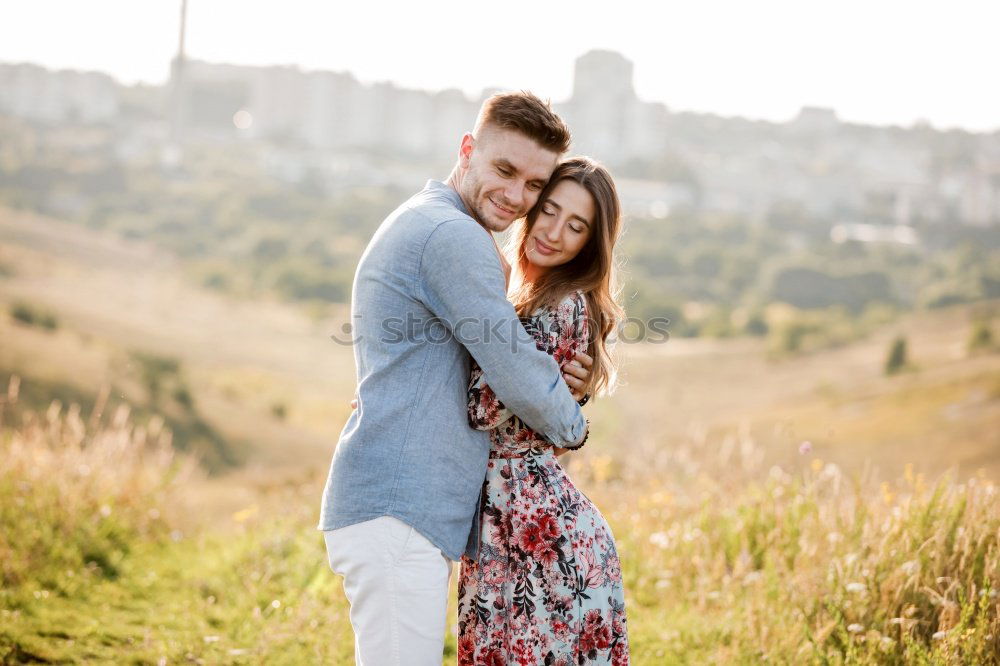 Similar – Image, Stock Photo Young loving couple hugging in the street.