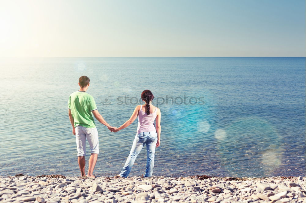 Happy family walking on the beach at the day time.