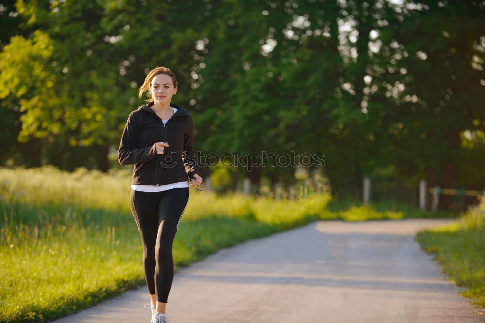 Similar – Healthy Woman Jogging in the Park with her Dog