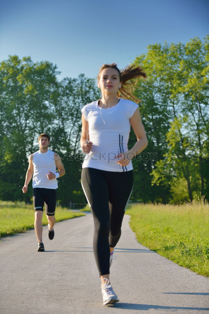 Similar – Image, Stock Photo Young couple running on a seafront promenade