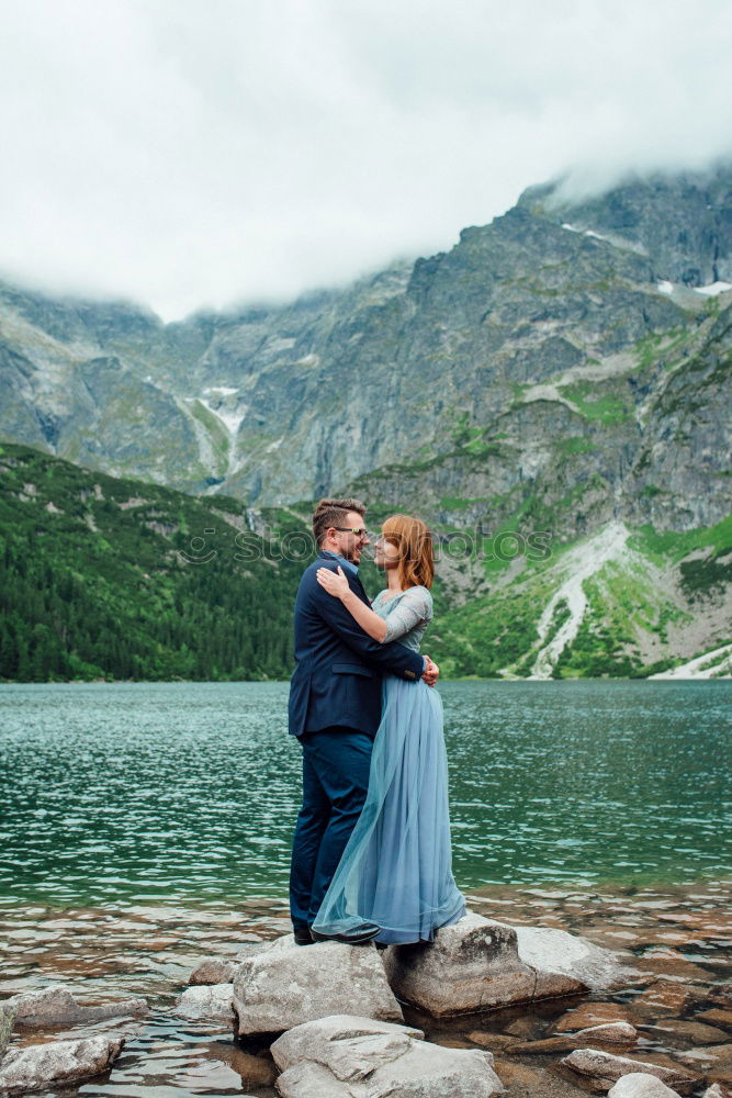 Similar – Women at lake in mountains