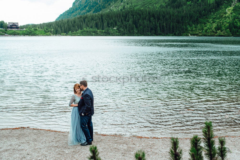 Similar – Women at lake in mountains