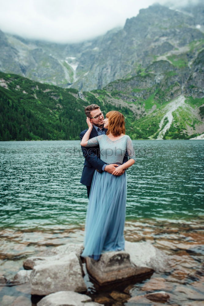 Similar – Women at lake in mountains