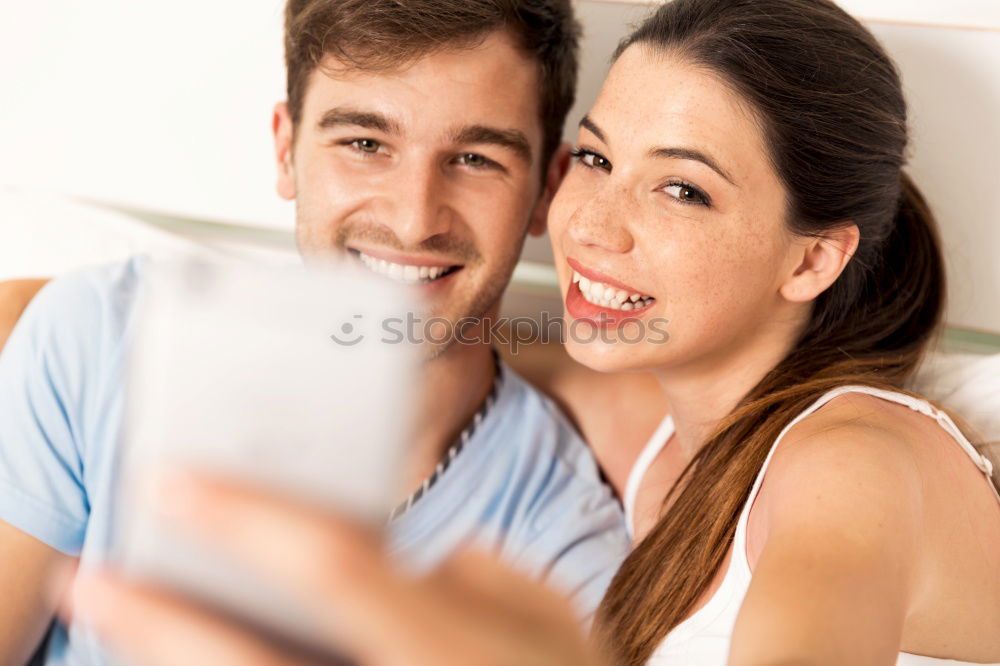 Similar – young cheerful couple taking a selfie