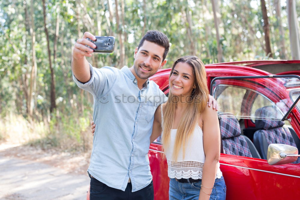 Similar – Young couple doing a selfie on the car