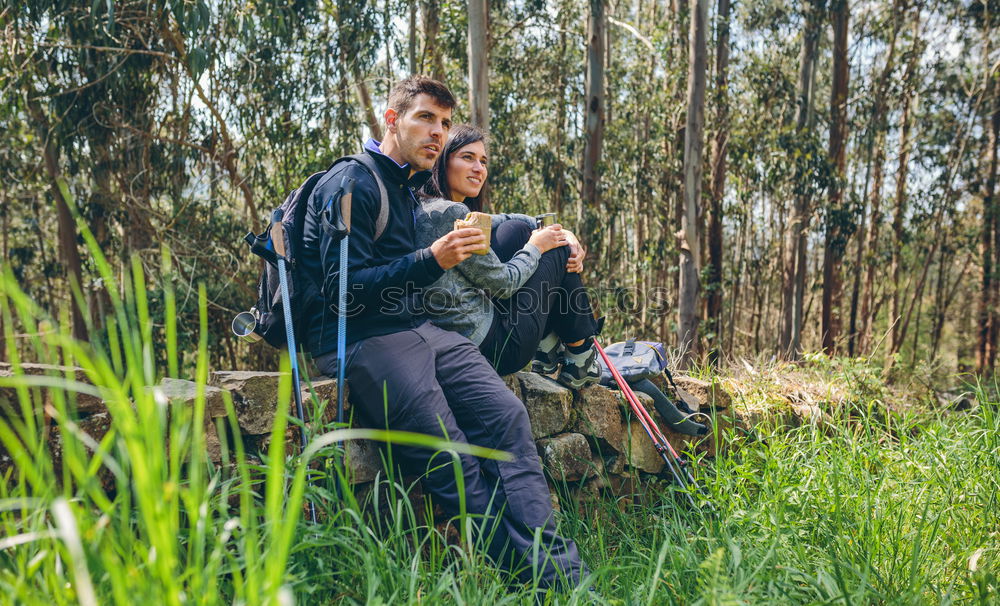 Similar – Image, Stock Photo Couple pausing while doing trekking