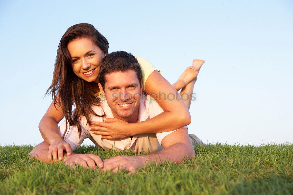 Similar – Happy smiling couple laying on green grass