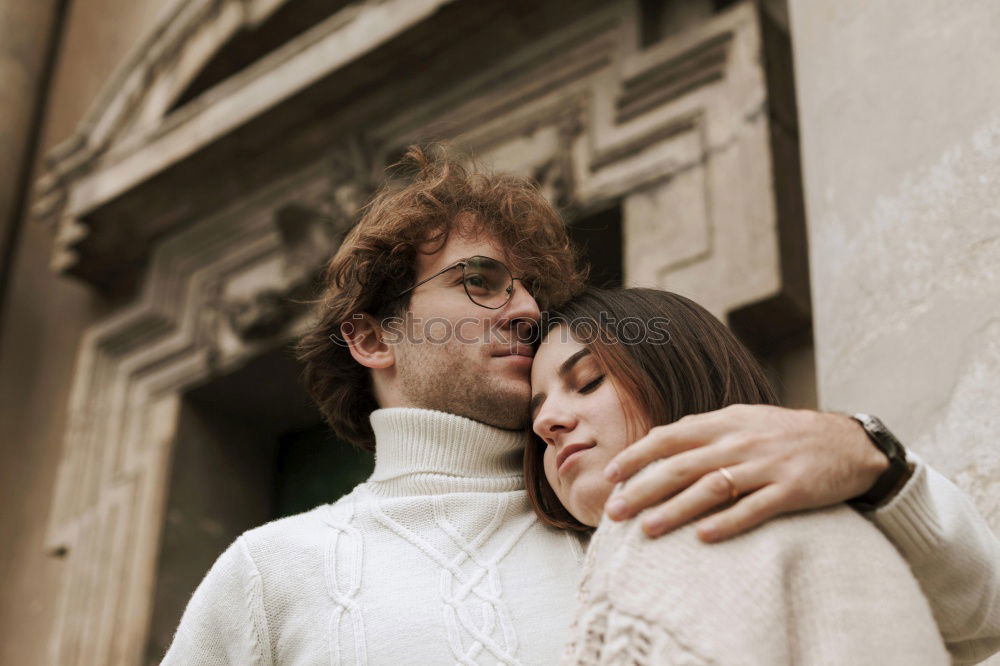 Similar – Image, Stock Photo Kissing couple at stone wall with metal decorated bars