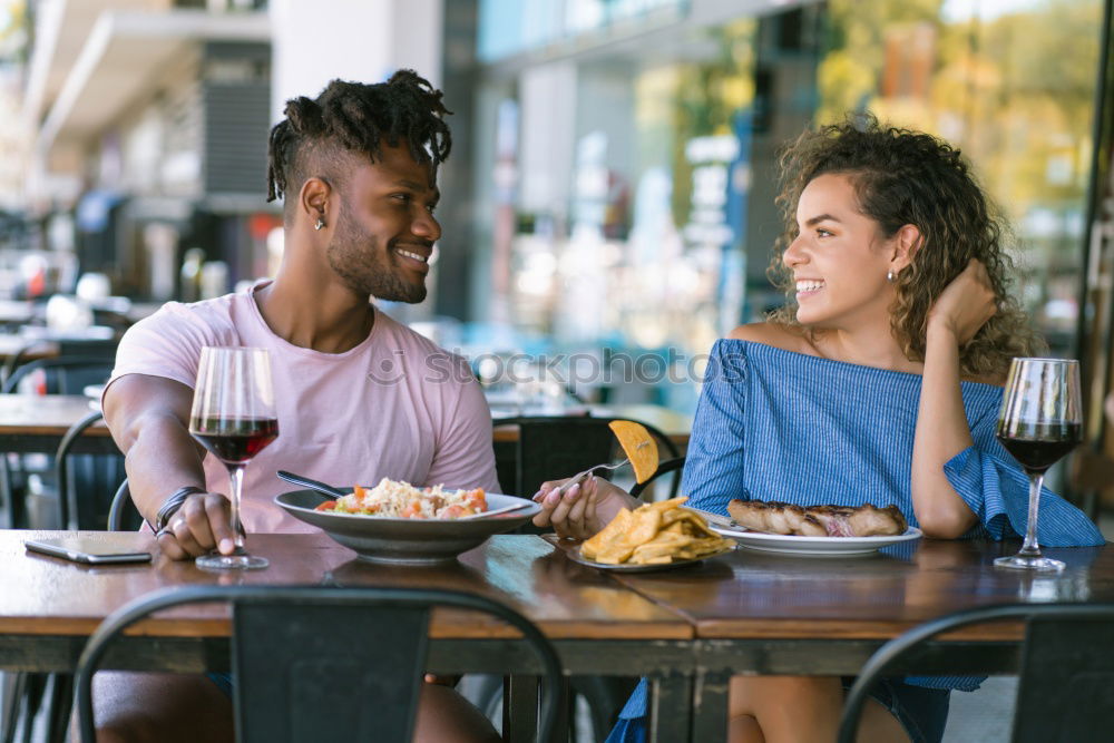 Couple eating pizza at date night in sunset