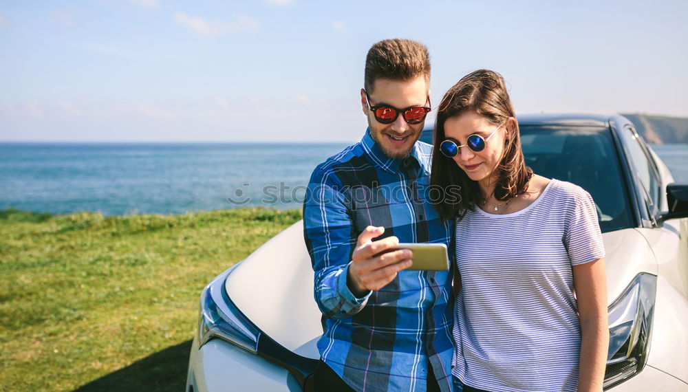 Similar – Young couple doing a selfie on the car