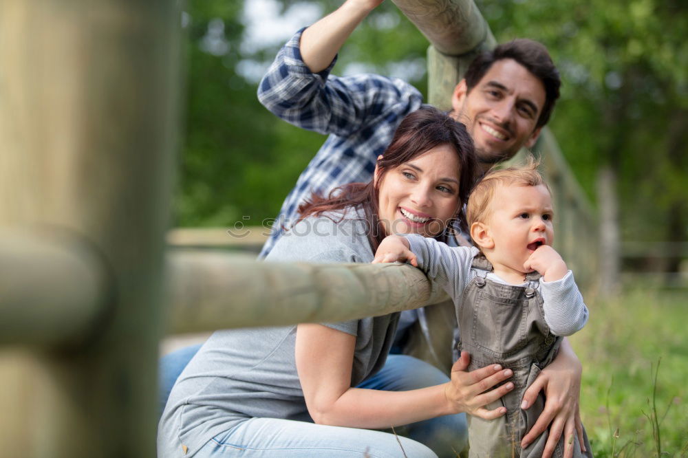 Similar – Image, Stock Photo Happy young family in a urban park.