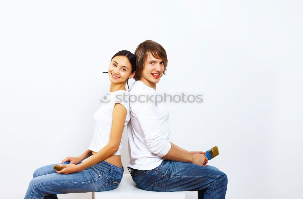 Similar – Side view Happy couple in love jumping against grey wall.