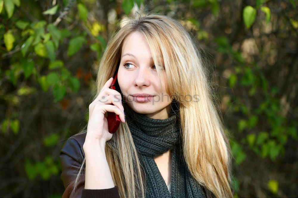 Smiling Woman in Autumn Fashion Talking on Phone