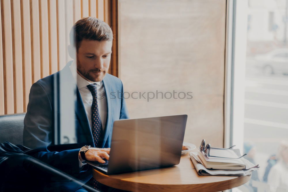 Similar – Geschäftsmann mit Blick auf das Smartphone im modernen Firmenbüro.