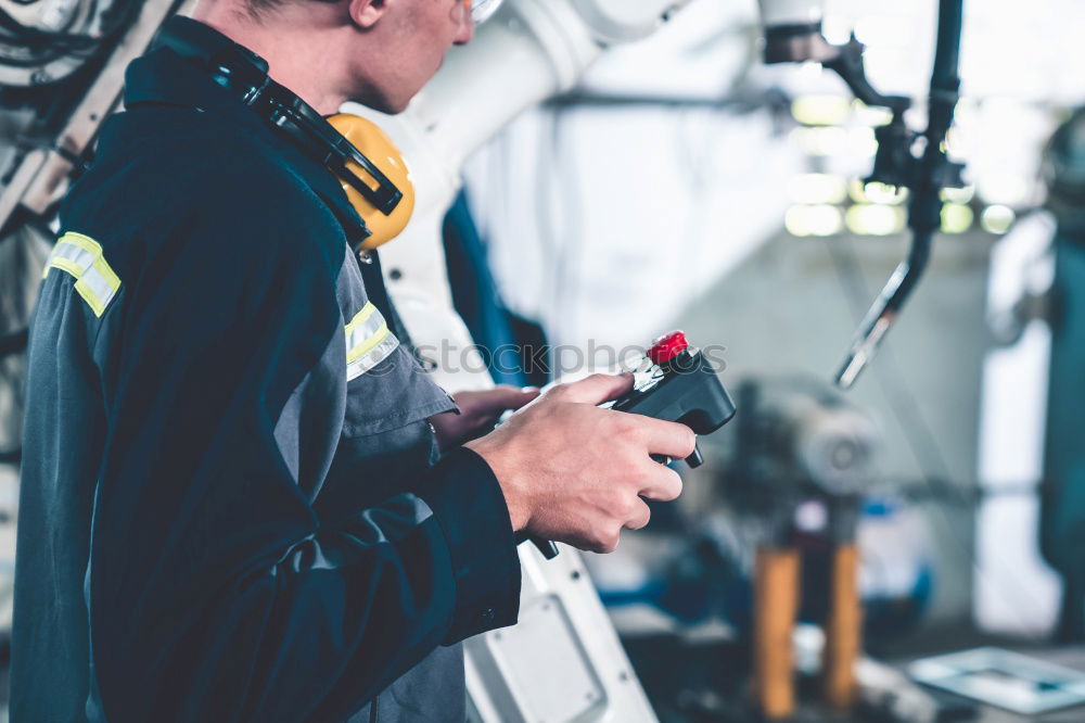 Similar – Professional Mechanic Repairing Car.