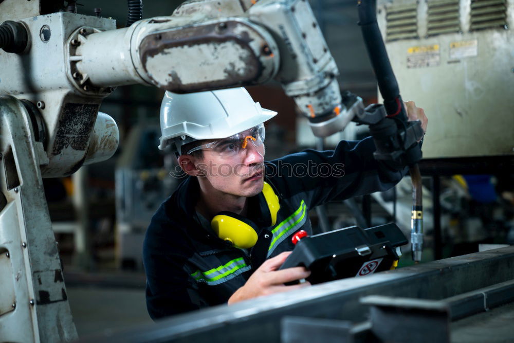 Similar – Image, Stock Photo Female mechanic operating a hoist to lift a compressor engine