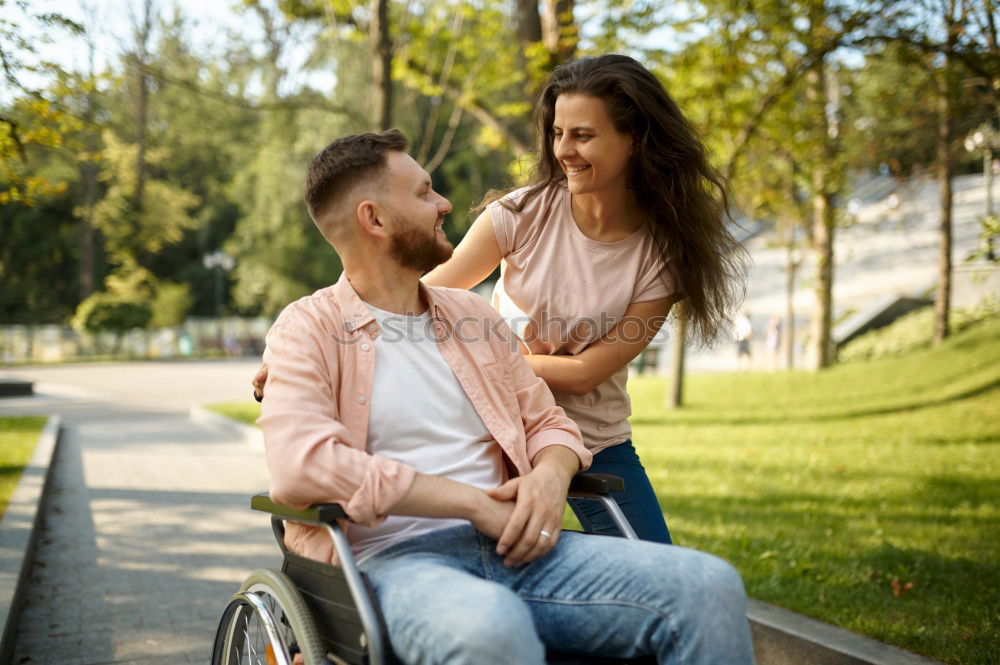 Similar – Foto Bild Frau und ihr Freund im Rollstuhl machen einen Spaziergang durch den Park an einem Fluss und genießen den Herbst