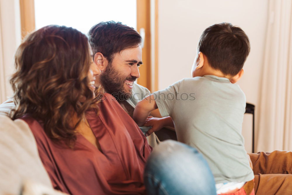 Similar – Happy family at home in the couch playing classic table games