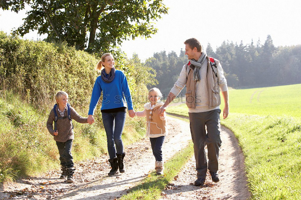 Similar – Grandparents and grandchild jumping on nature path