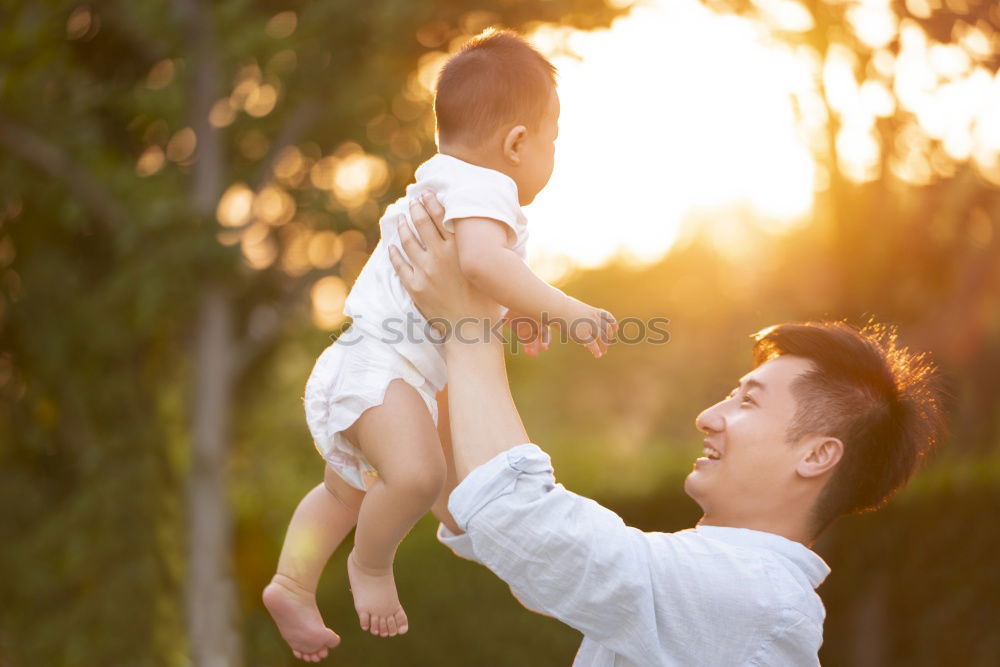 Father and daughter playing at the park at the day time.