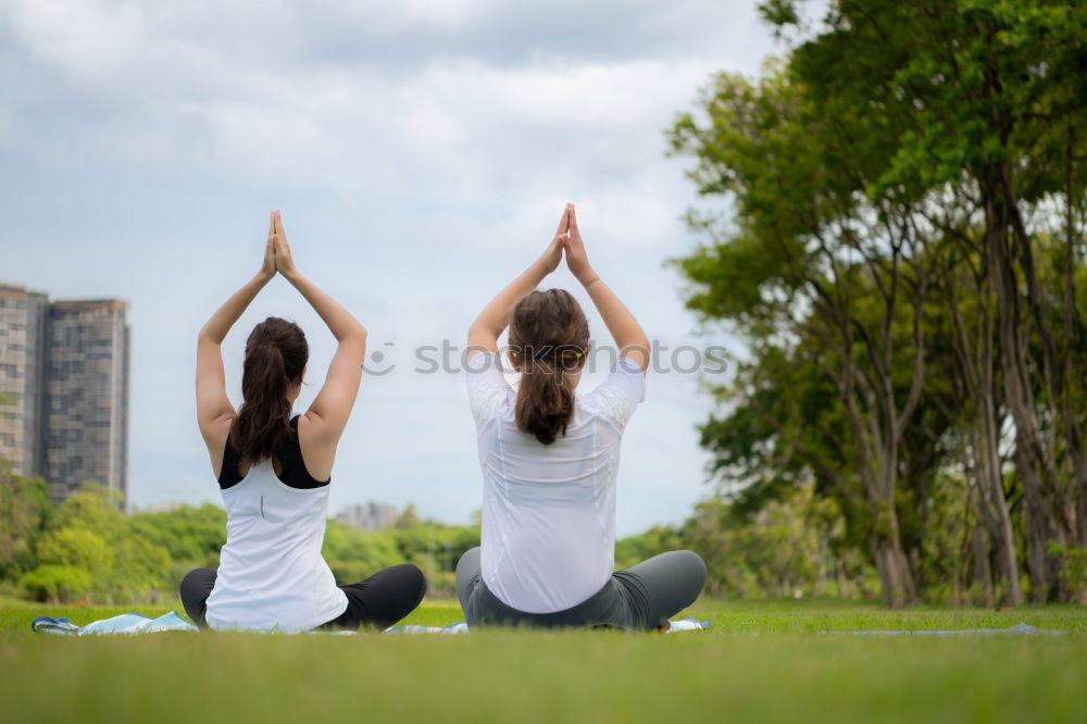 Similar – Image, Stock Photo Mother and daughter doing yoga exercises on grass in the park at the day time