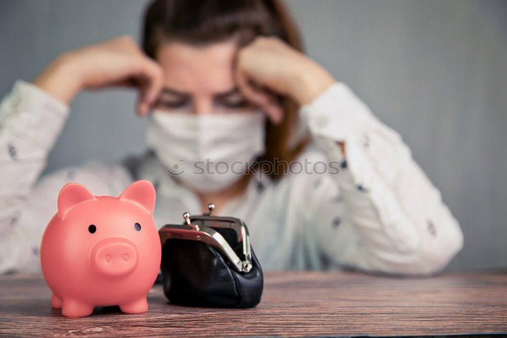 Similar – Unhappy man angry at his piggy bank