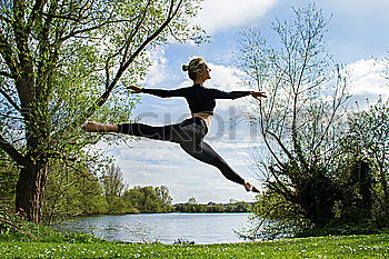 Image, Stock Photo Young rhythmic gymnast doing split jump during ribbon exercises.