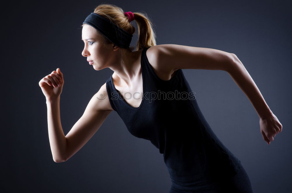 Similar – Close up side view profile portrait of one young athletic woman shadow boxing in sportswear in gym over dark background, looking away