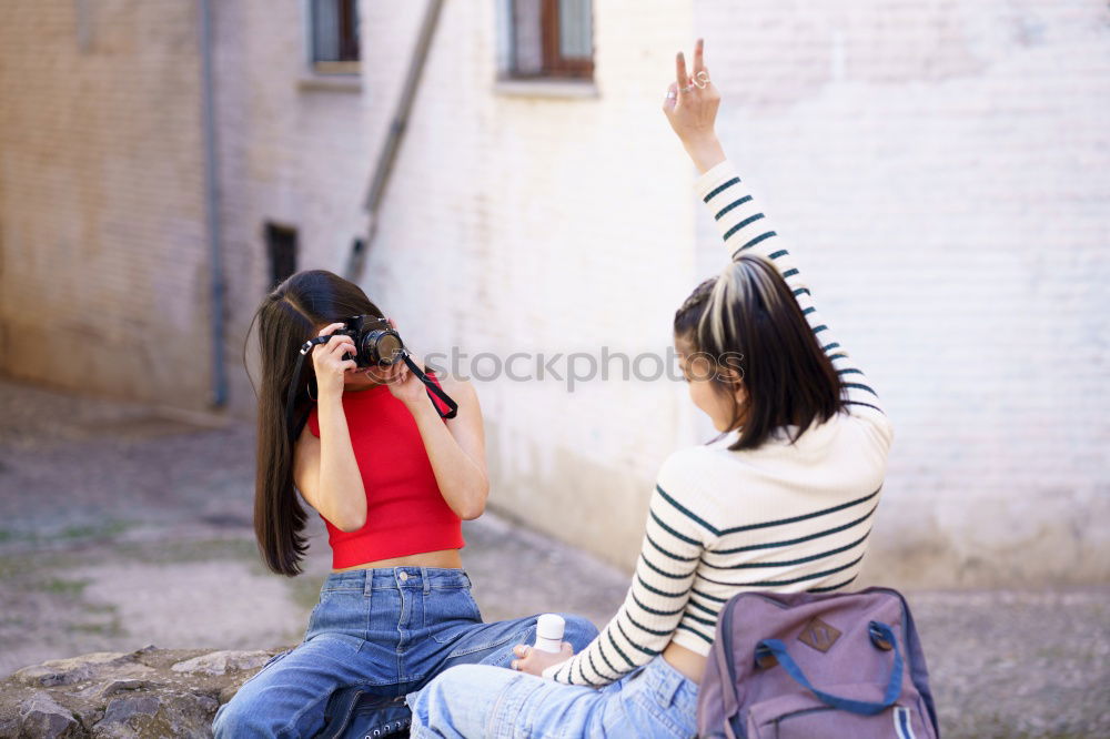 Similar – Beautiful women seating in the street.