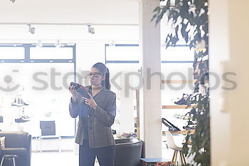 Similar – Mature woman watching TV at home sitting on couch