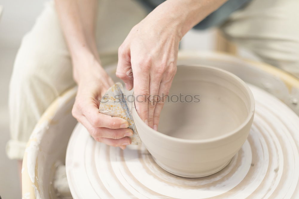 Similar – Image, Stock Photo Young female sitting by table and making clay or ceramic