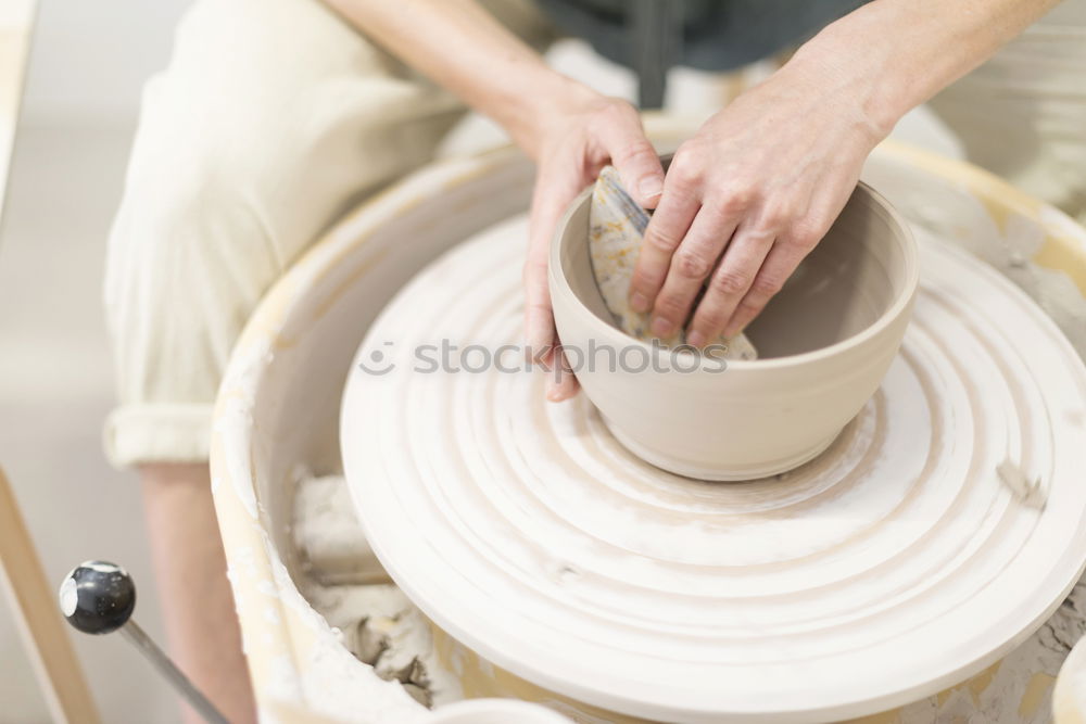 Similar – Image, Stock Photo Young female sitting by table and making clay or ceramic