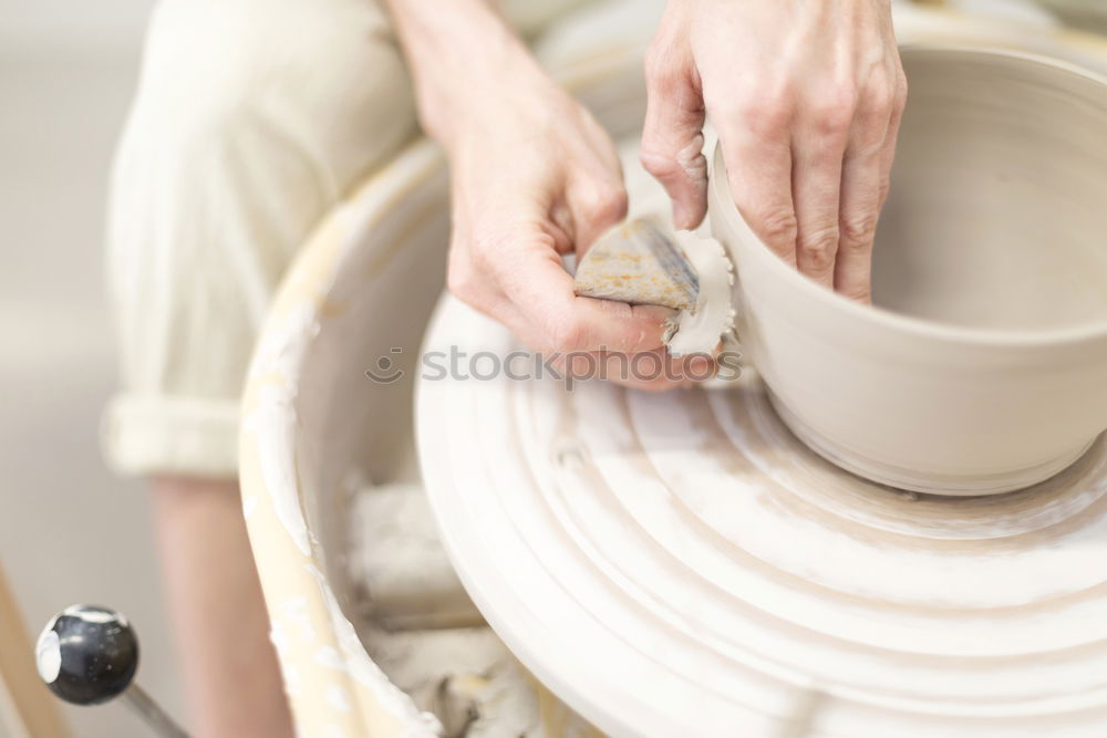 Similar – Image, Stock Photo Young female sitting by table and making clay or ceramic