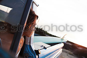 Similar – Unrecognizable man resting feet up sitting on the car