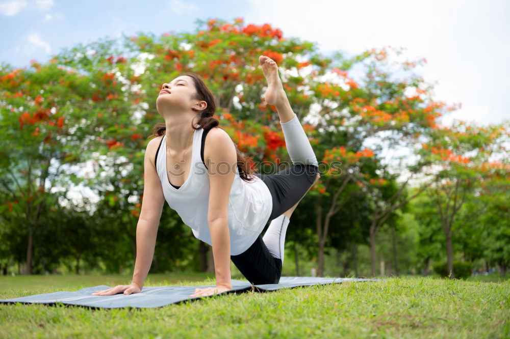 Similar – Young woman doing yoga in nature.