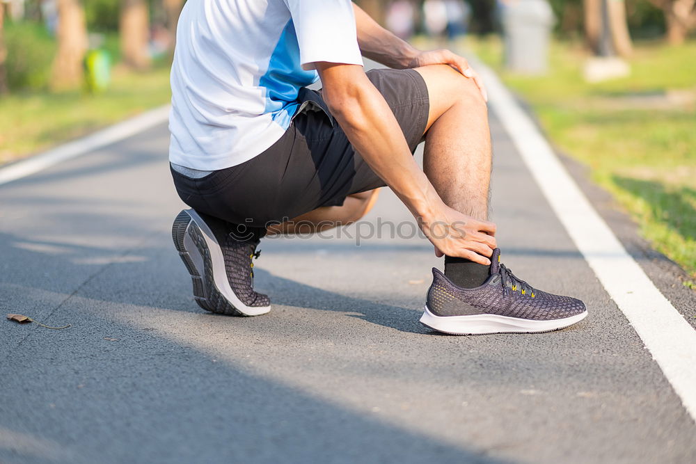 Similar – Runner get ready for run, tying sneakers shoelaces