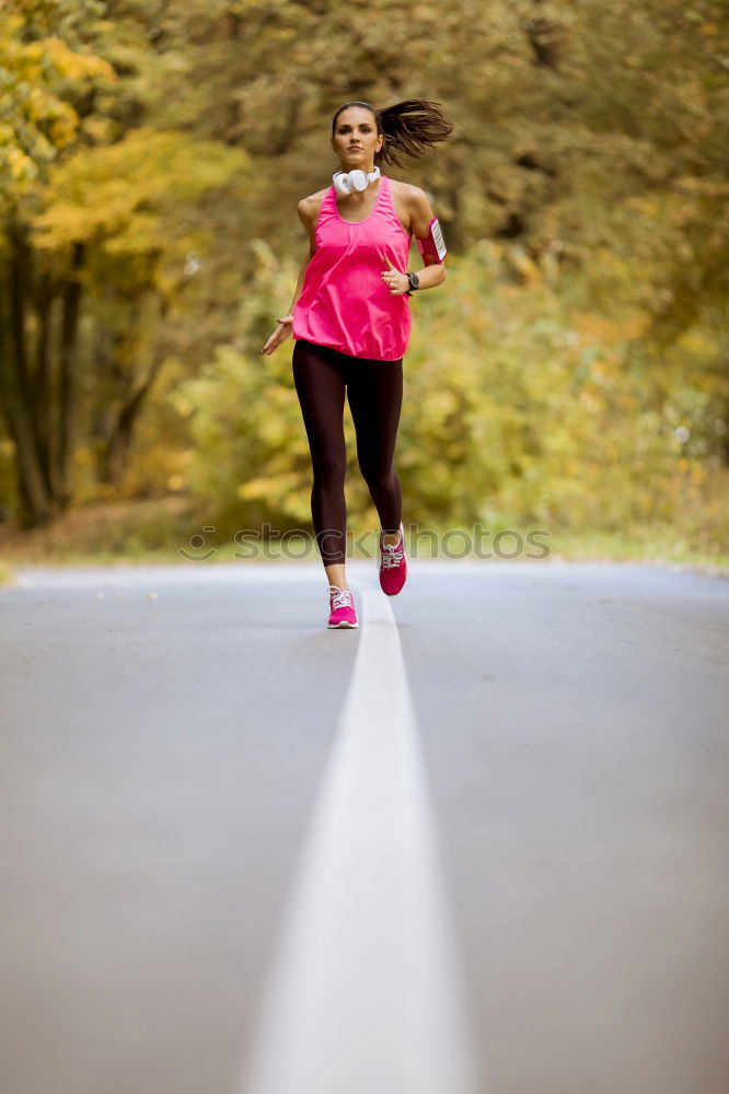 Similar – Young fitness woman runner running on city bridge.