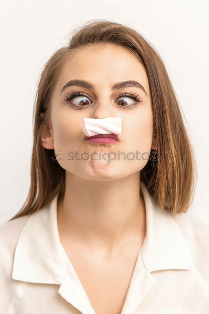 Similar – portrait of young woman eating bubble gum in brick background