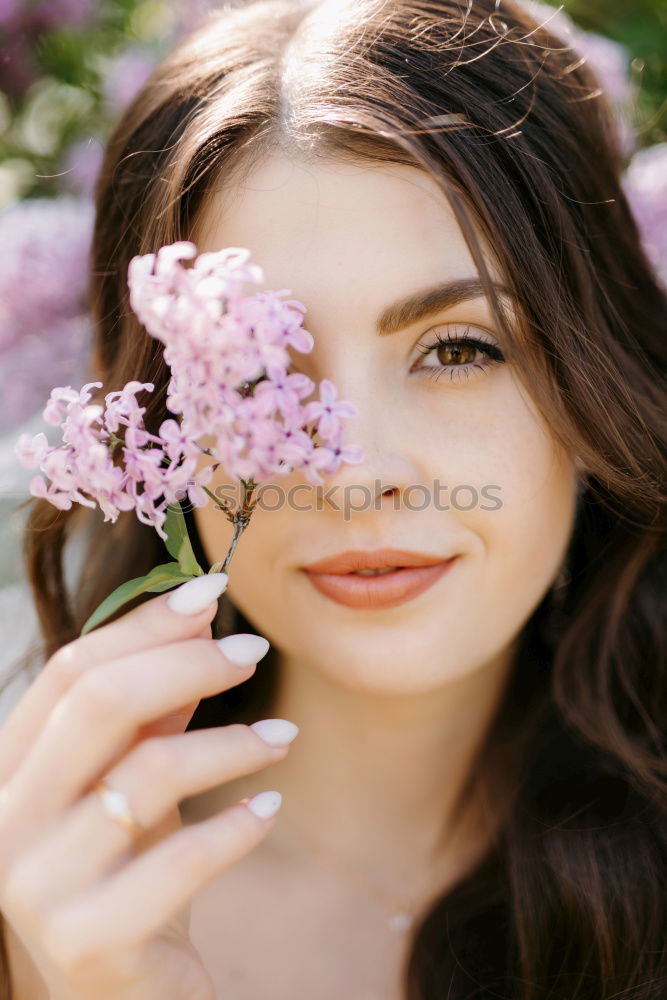 Similar – Pretty woman standing with white flowers