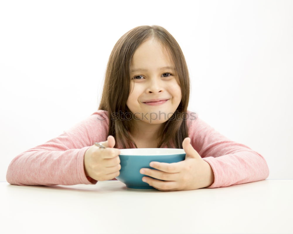 Similar – happy kid girl drinking tea for breakfast.