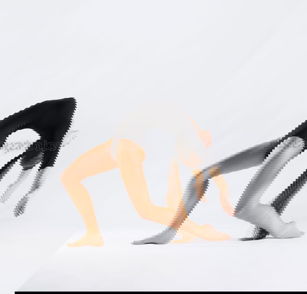 Similar – Image, Stock Photo young, slim woman swings her upper body and her long, brunette hair in front of her legs, standing barefoot in front of a white wall