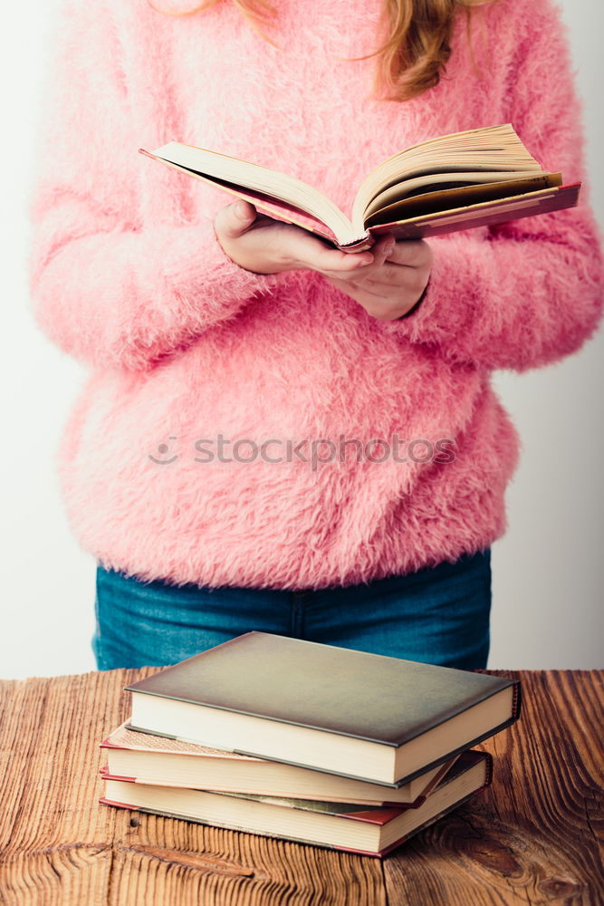 Similar – Image, Stock Photo Young girl turning the pages of book in bookstore