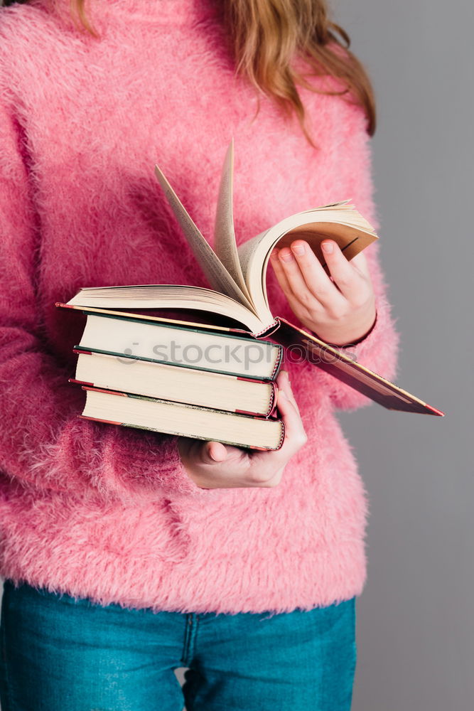 Similar – Image, Stock Photo Young girl turning the pages of book in bookstore