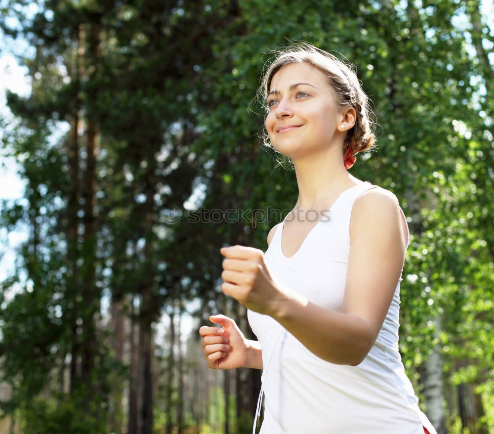 Similar – Woman jogging along a country road while listening to music